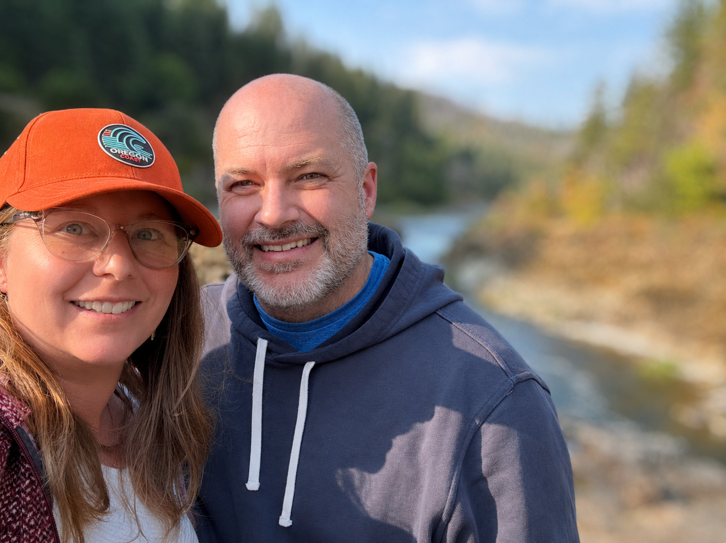 Brandon and Stacey Gresham outdoors by a river